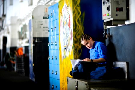 US Navy 120210-N-XE109-046 Aviation Boatswain's Mate (Handling) Airman Danielle M. Jones studies for an upcoming advancement exam in the hangar bay