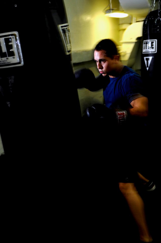 US Navy 120213-N-UT411-221 Airman Tanner Schaffer, assigned to Strike Fighter Squadron (VFA) 81, boxes in the sweat box gym aboard the Nimitz-class