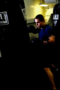 US Navy 120213-N-UT411-221 Airman Tanner Schaffer, assigned to Strike Fighter Squadron (VFA) 81, boxes in the sweat box gym aboard the Nimitz-class