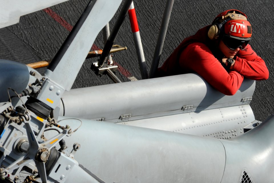 US Navy 120216-N-VO377-182 An aviation ordnanceman rests on the flight deck of the Nimitz-class aircraft carrier USS Abraham Lincoln (CVN 72)