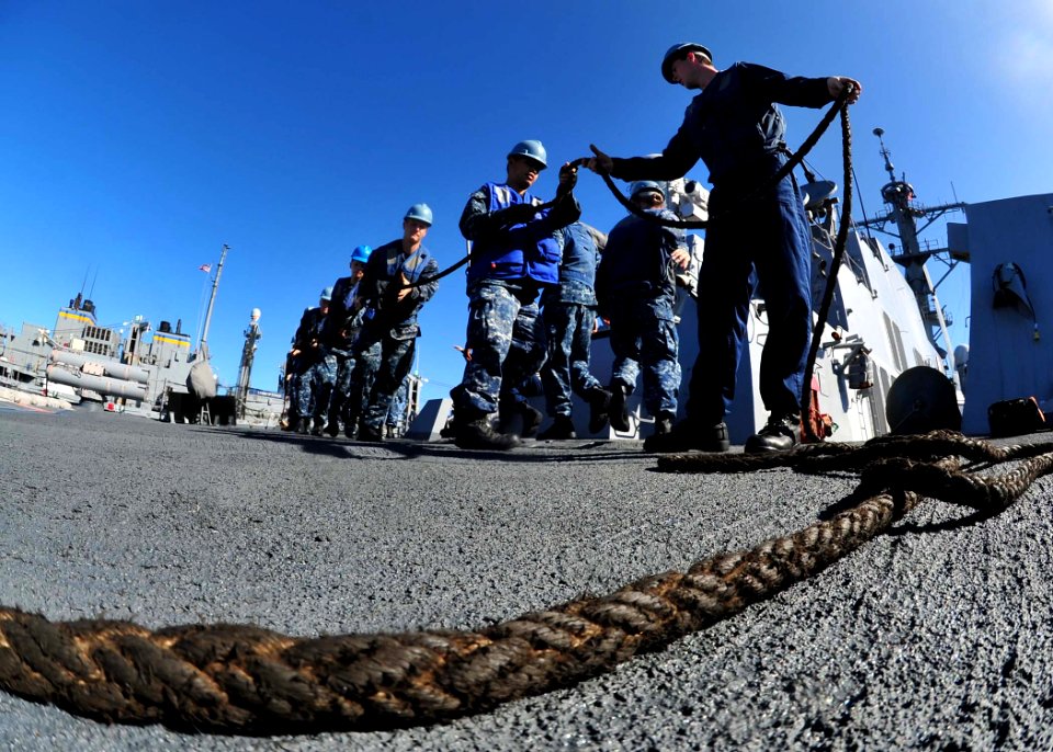 US Navy 120212-N-ED900-621 Sailors aboard the guided-missile destroyer USS Pinckney (DDG 91) maintain control of a line pulling a fueling probe dur