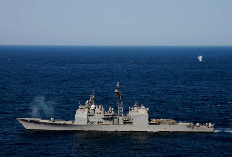 US Navy 120214-N-BC134-698 The guided-missile cruiser USS Bunker Hill (CG 52) fires an MK-45 5 inch-54-caliber lightweight gun during a pre-action
