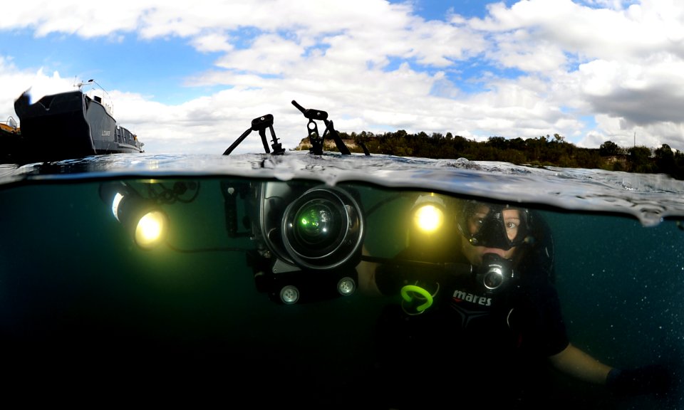 US Navy 120213-N-XD935-107 Mass Communication Specialist 2nd Class Kori Melvin descends from the surface to document diving operations in the harbo