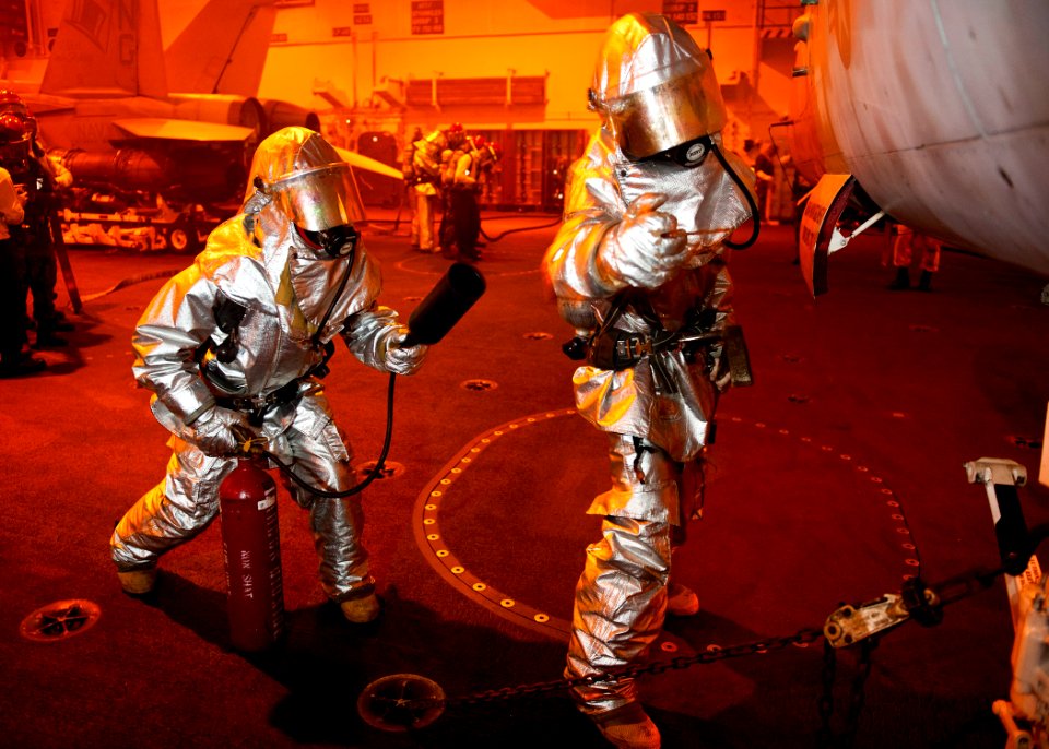US Navy 120214-N-BT887-148 Sailors check an aircraft for a simulated fire during a general quarters training exercise aboard the Nimitz-class aircr