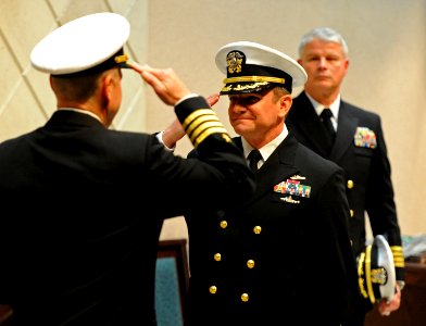 US Navy 120216-N-AQ172-148 Capt. Wesley Guinn salutes Capt. Mark Davis at a change of command ceremony held at Naval Support Activity Naples photo