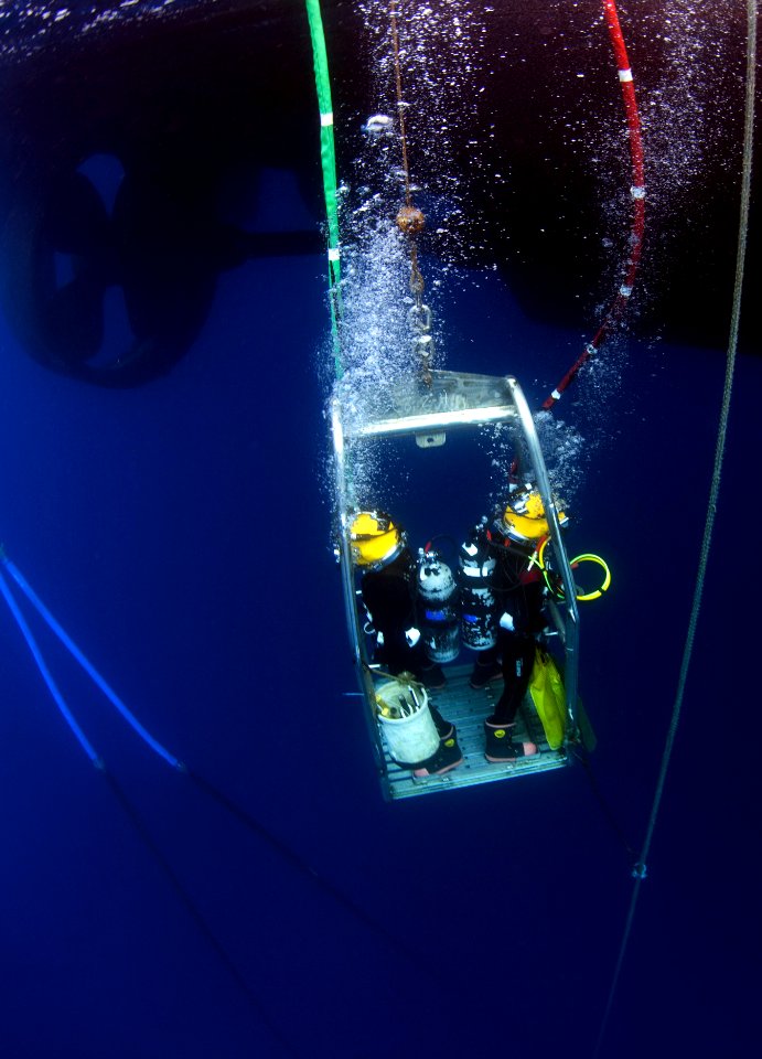 US Navy Divers, alongside the Joint POW-MIA Accounting Command, search for an unaccounted-for service member who went missing during World War II 121017-N-OT964-107
