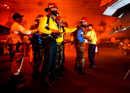 US Navy 120214-N-BT887-131 Sailors fight a simulated fire during a general quarters training exercise aboard the Nimitz-class aircraft carrier USS