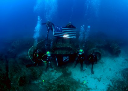 US Navy divers, alongside the Joint POW-MIA Accounting Command, search for an unaccounted-for service member who went missing during World War II 121019-N-OT964-065