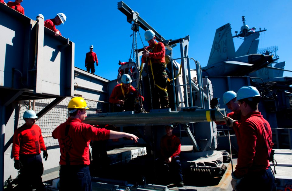 US Navy 120214-N-OY799-079 Sailors lower a rolling airframe missile on the flight deck of the Nimitz-class aircraft carrier USS John C. Stennis (CV