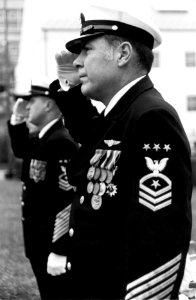 US Navy 790928-N-0000X-002 Master Chief Petty Officer of the Navy (MCPON) Thomas S. Crow and MCPON Robert J. Walker, rear, render hand salutes