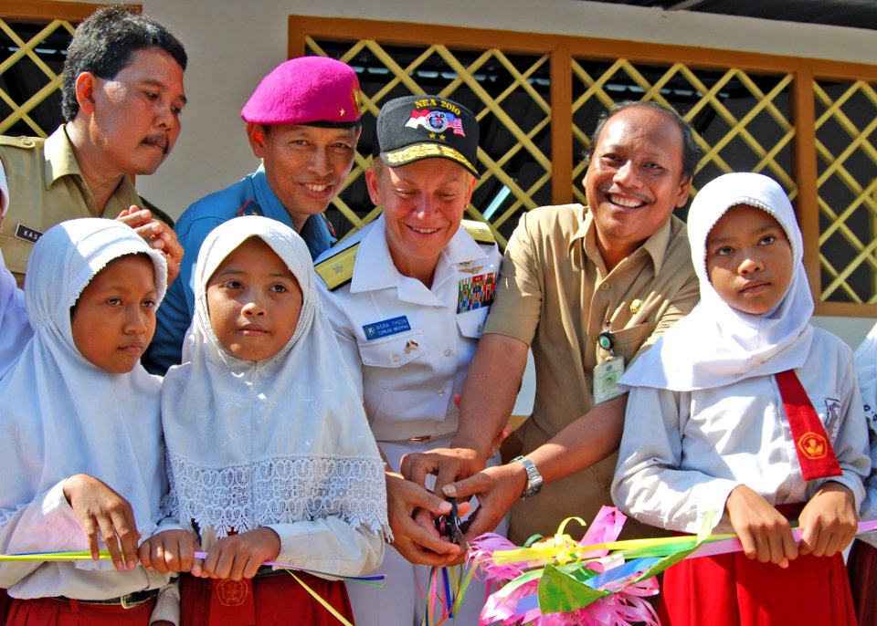 US Navy Rear Adm. Nora W. Tyson, center, commander of Task Force 73, is joined by Indonesian navy Brig. Gen. Halim, center left, the headmaster and students of Weru Village Primary School