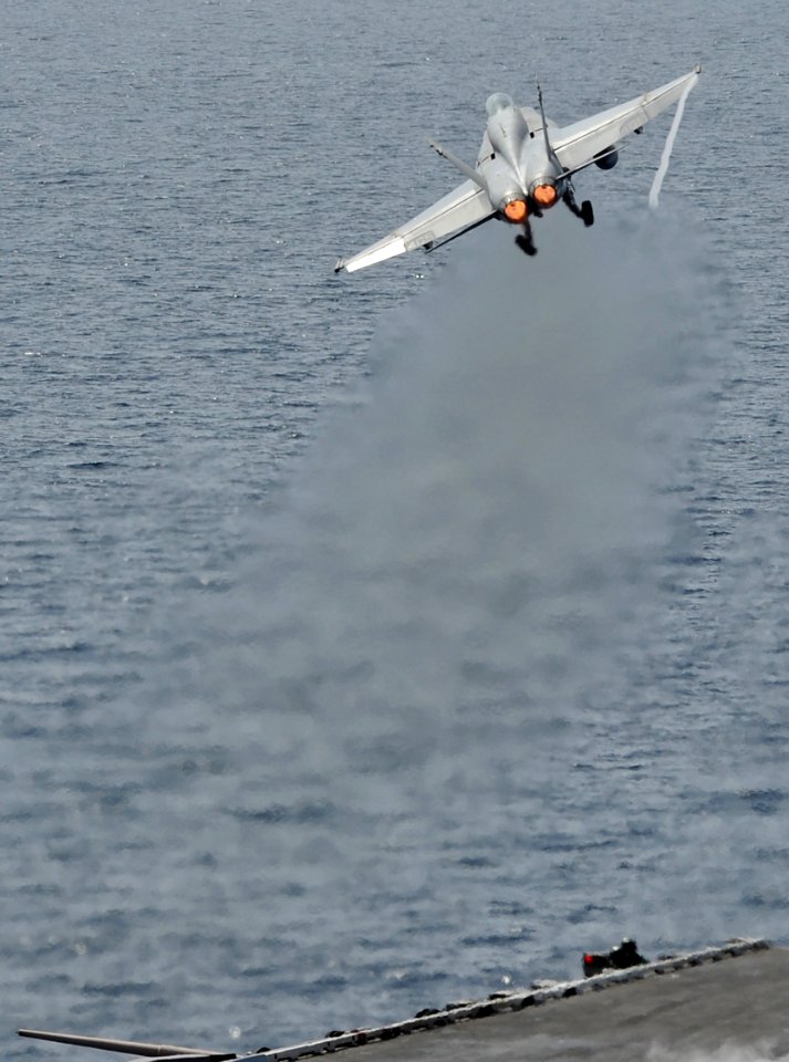 US Navy 120216-N-VO377-380 An F-A-18C Hornet assigned to the Blue Blasters of Strike Fighter Squadron (VFA) 34 launches from the flight deck of the