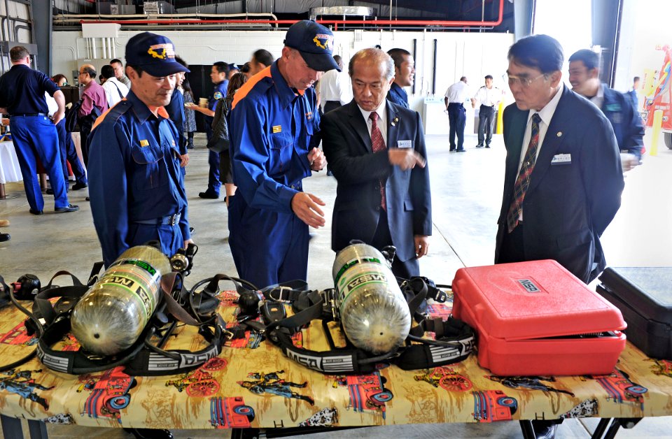 US Navy 121003-N-7441H-004 Guests look over firefighting equipment during a ceremony officially opening the new White Beach Fire Station