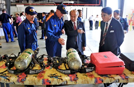 US Navy 121003-N-7441H-004 Guests look over firefighting equipment during a ceremony officially opening the new White Beach Fire Station photo