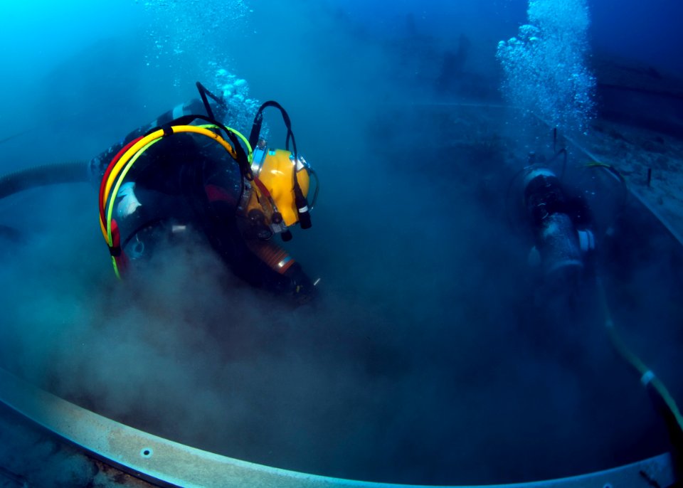 US Navy Divers, alongside the Joint POW-MIA Accounting Command, search for an unaccounted-for service member who went missing during World War II 121017-N-OT964-058
