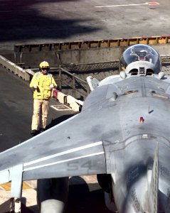 US Navy 990414-N-6240R-511 The Flight Deck Handler guides the last returning AV-8B
