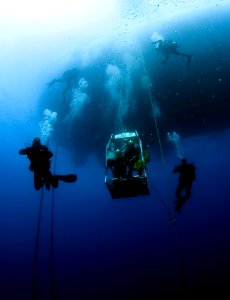 US Navy divers, alongside the Joint POW-MIA Accounting Command, search for an unaccounted-for service member who went missing during World War II 121019-N-OT964-046