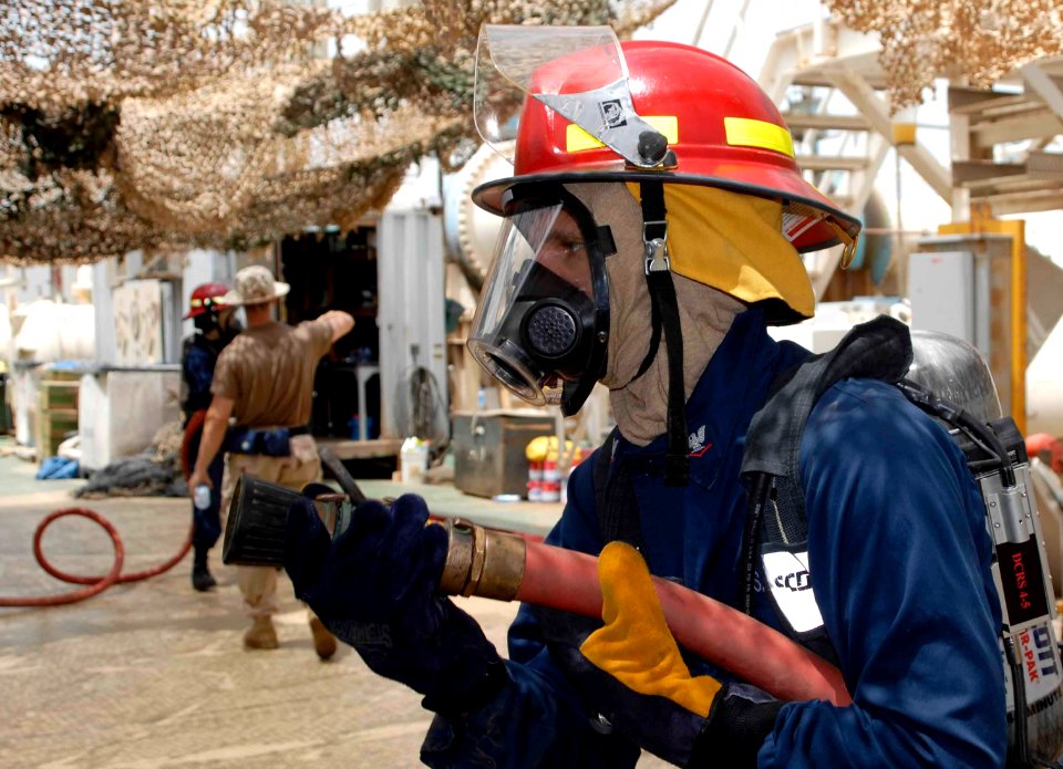 US Navy http-www.navy.mil-management-photodb-photos-100522-N-3358S-064 A Sailor assigned to the amphibious transport dock ship USS Mesa Verde (LPD 19) engages a mock fire aboard the Al Basra Oil Terminal