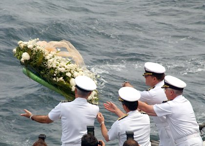 US Navy members toss a wreath into the sea during a memorial ceremony commemorating the one-year anniversary of the 911 terrorist attacks