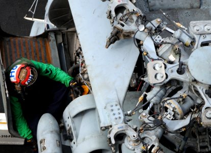 US Navy http-www.navy.mil-management-photodb-photos-100603-N-4236E-060 A Sailor works on the engine of an SH-60F Sea Hawk helicopter aboard USS Dwight D. Eisenhower (CVN 69)