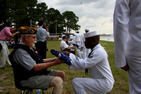 US Navy http-www.navy.mil-management-photodb-photos-100603-N-6936D-176 Logistics Specialist 2nd Class Kevin Johnson, from Brooklyn N.Y., presents an American flag to Don Lloyd