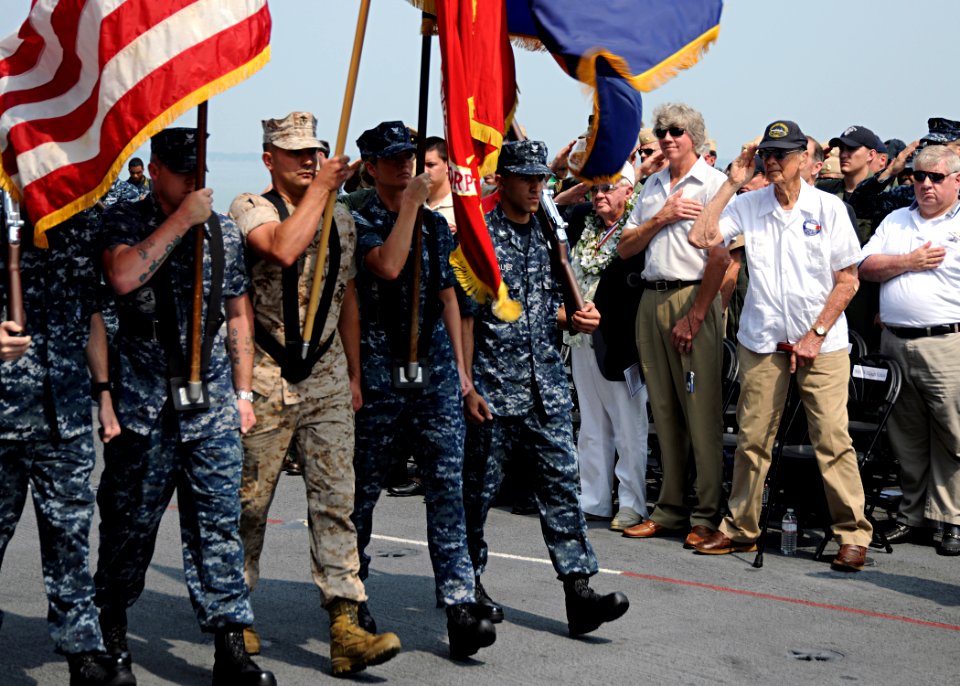 US Navy http-www.navy.mil-management-photodb-photos-100604-N-3885H-117 Guests aboard the aircraft carrier USS George H.W. Bush (CVN 77) salute as the ship's color guard parades the colors