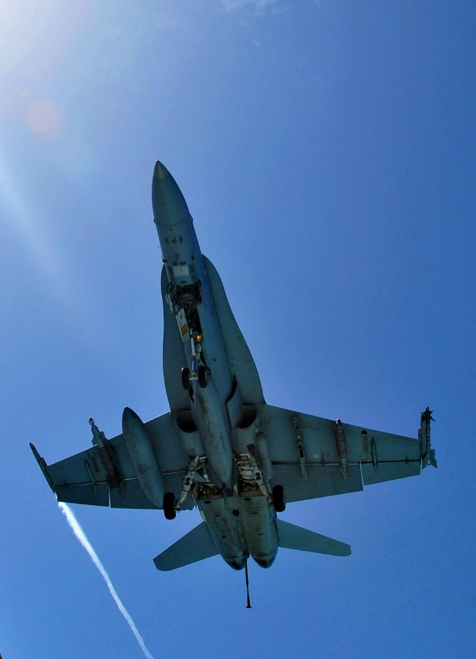 US Navy http-www.navy.mil-management-photodb-photos-100601-N-3595W-001 n FA-18C Hornet assigned to Carrier Air Wing (CVW) 7 flies over the Nimitz-class aircraft carrier USS Dwight D. Eisenhower (CVN 69)