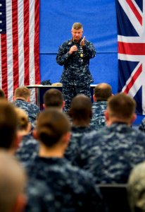 US Navy Master Chief Petty Officer of the Navy (MCPON) Rick West answers a Sailor's question during an all-hands call at Joint Analysis Center Royal Air Force Molesworth