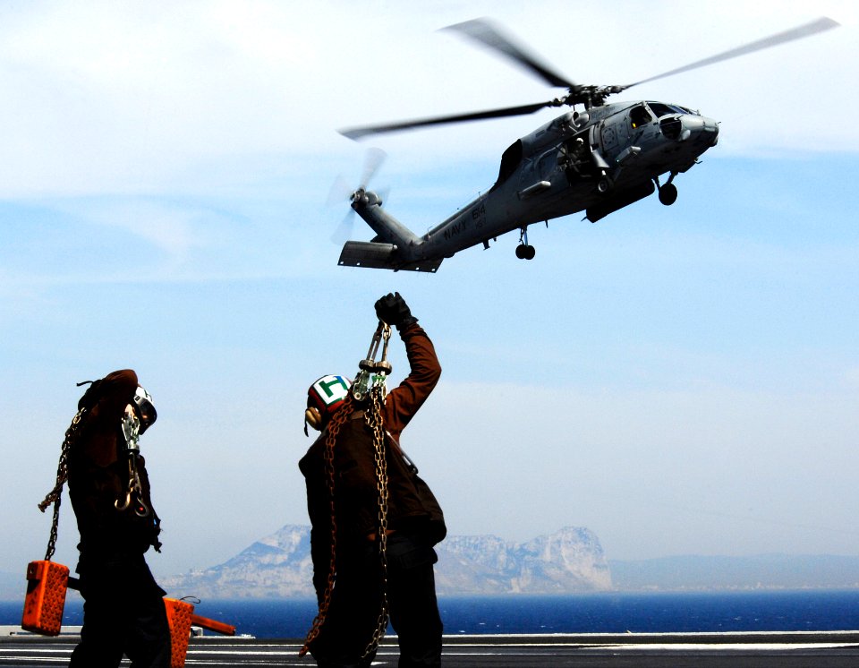 US Navy Sailors admire the scenery from the flight deck during a transit of the Strait of Gibraltar aboard the Nimitz-class aircraft carrier USS Harry S. Truman (CVN 75)