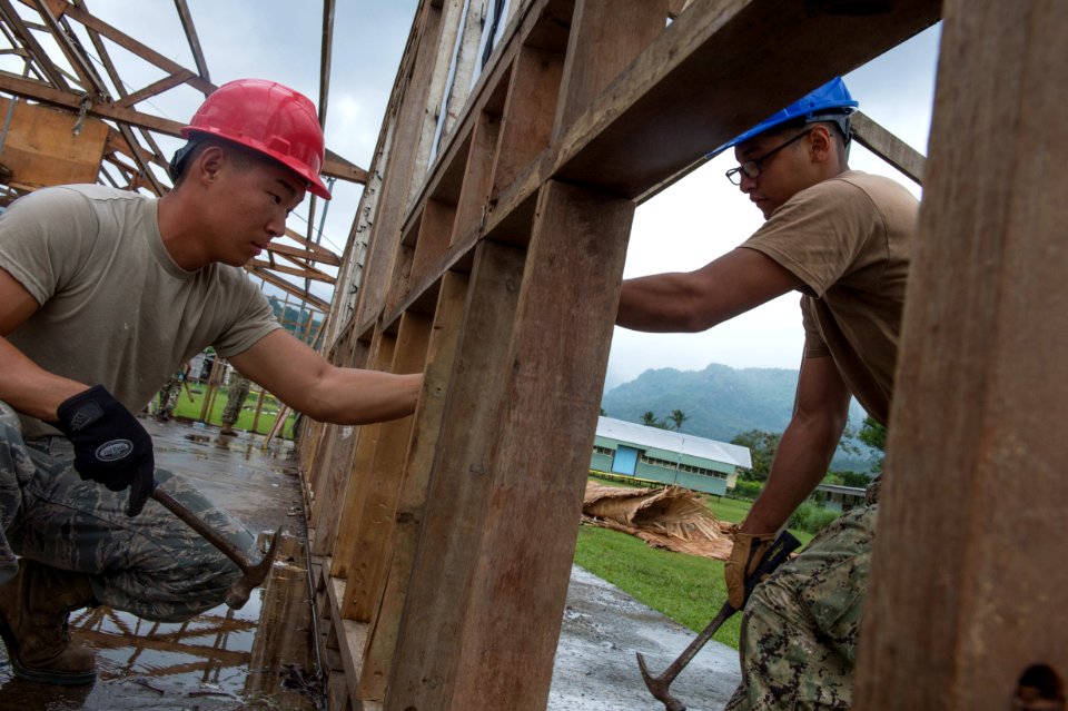 US Navy Seabees and US Air Force RED HORSE engineers build a school in Papua New Guinea during Pacific Partnership 150703-N-UQ938-019