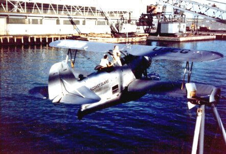 USCG J2F-6 Duck is hoisted abaord a ship 1946
