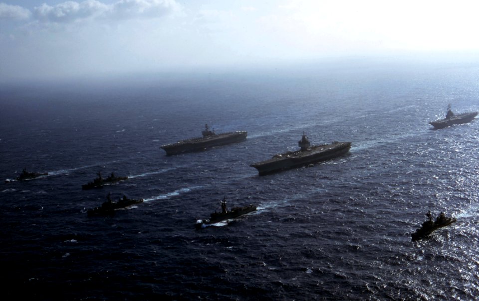 USS Enterprise (CVAN-65), USS America (CVA-66) and USS Oriskany (CVA-34) cruise together in the South China Sea on 28 January 1973