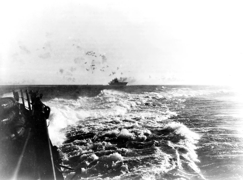 USS Enterprise (CV-6) under attack and burning during the Battle of the Eastern Solomons, 24 August 1942 (NH 97778)