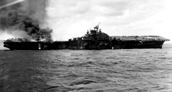 USS Franklin (CV-13) burning and listing in March 1945