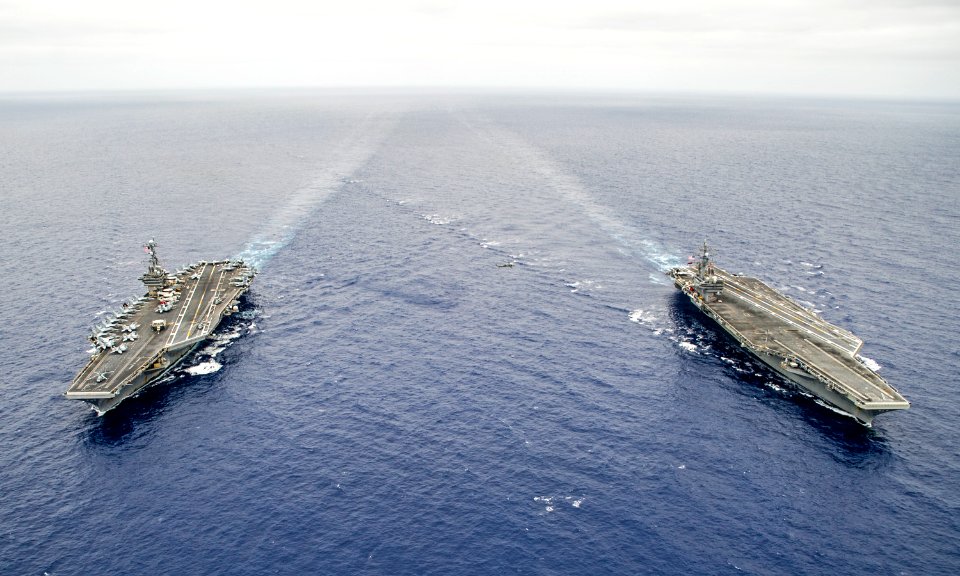 USS George Washington, left, and USS Ronald Reagan are underway before conducting a hull-swap. (20480681852)