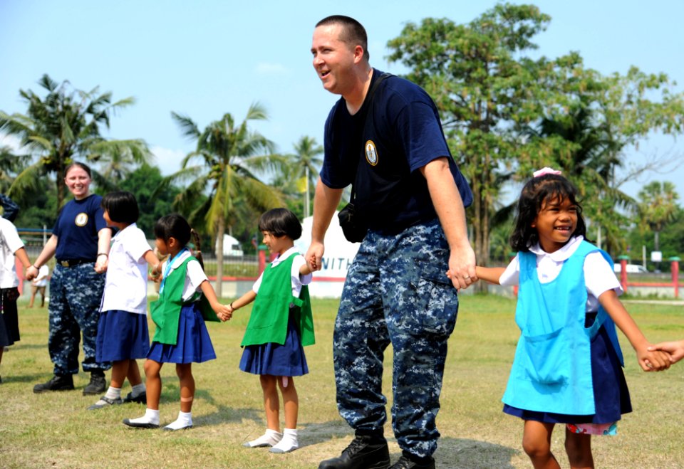 USS Germantown sailors play with children during community service project 120223-N-LP801-220