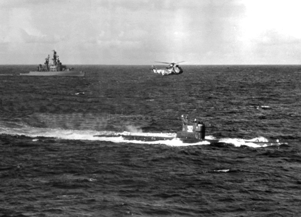 USS Harry E. Yarnell (DLG-17) and a SH-3A Sea King escort a Soviet Whiskey-class submarine c1967