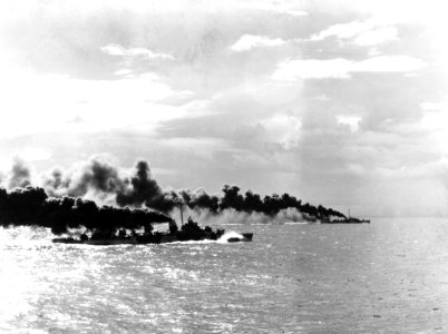 USS Heermann (DD-532) and USS John C. Butler (DE-339) lay a smoke screen during the Battle off Samar, 25 October 1944 (80-G-288885)