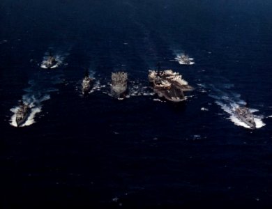 USS Kansas City (AOR-3) refueling USS Coral Sea (CV-43) and escorts, in 1983 photo