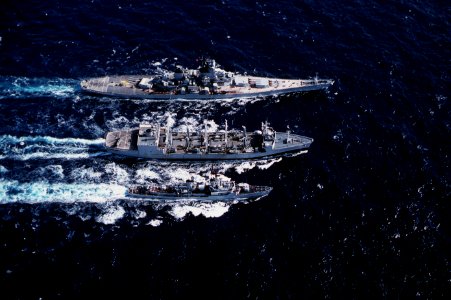 USS Kansas City (AOR-3) replenishes USS New Jersey (BB-62) and USS Buchanan (DDG-14) in the Pacific Ocean on 12 August 1983 (6372764) photo
