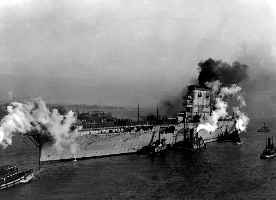 USS Lexington (CV-2) with tugs in January 1928