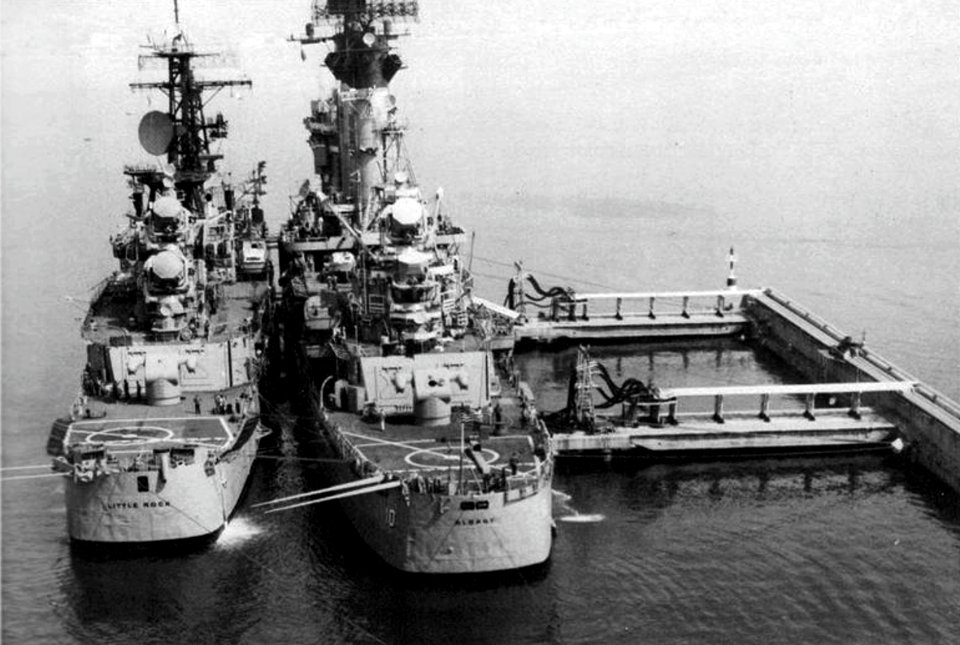 USS Little Rock (CG-4) and USS Albany (CG-10) docked at the refueling pier at Geata, Italy, in 1976
