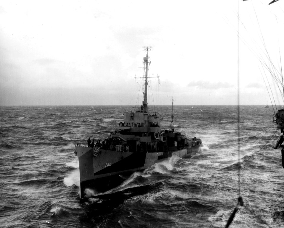 USS Moore (DE-240) coming alongside the escort carrier USS Core (CVE-13) in the Atlantic Ocean on 9 April 1945 (NH 45727)