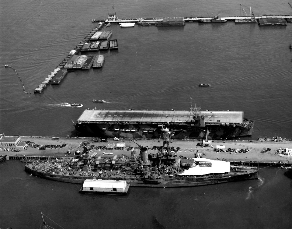 USS New York (BB-34)and USS Charger (ACV-30) at the Norfolk Naval Shipyard, Portsmouth, Virginia (USA), 11 August 1942(80-G-11058)