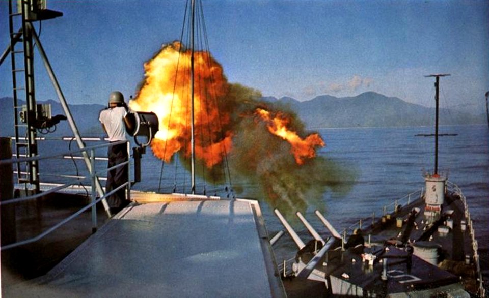 USS Oklahoma City (CLG-5) firing its 152 mm guns during a gunfire support mission off Vietnam, in 1965-1966