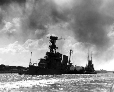 USS Raleigh (CL-7) being kept afloat by a barge lashed alongside, Pearl Harbor, 7 December 1941 (80-G-19938)