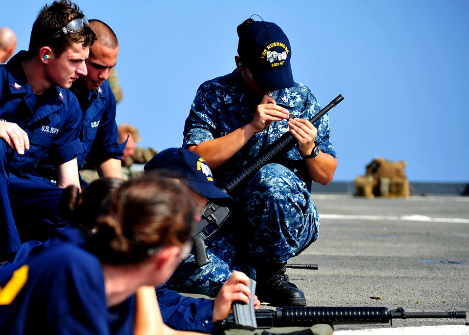 USS Rushmore sailor adjusts rifle 121030-N-YQ852-006