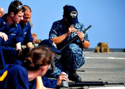 USS Rushmore sailor adjusts rifle 121030-N-YQ852-006