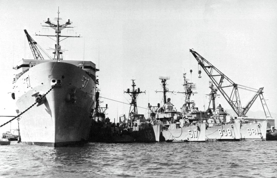 USS Samuel Gompers (AD-37) in port with destroyers alongside, circa in 1968