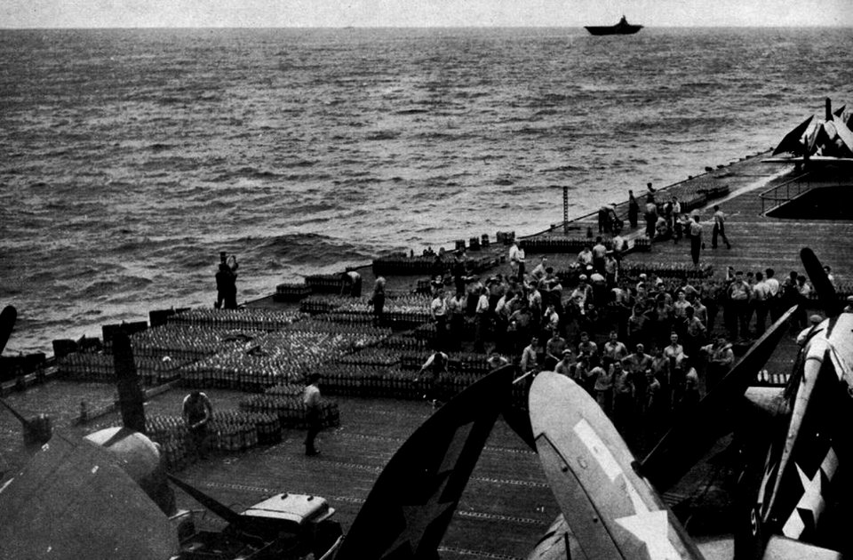 USS Shangri-La (CV-38) loads ammunition, in 1945